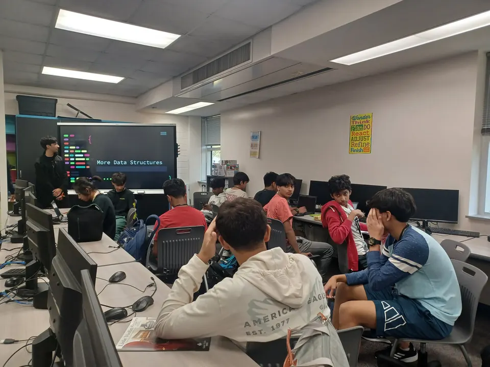 An officer presents the "More Data Structures" lesson to members at their desks.